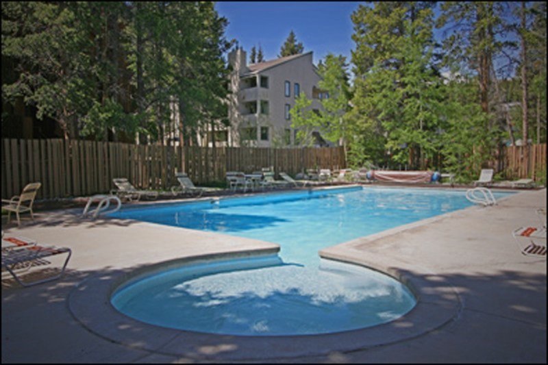 The Columbine pool in summer, ringed by pines